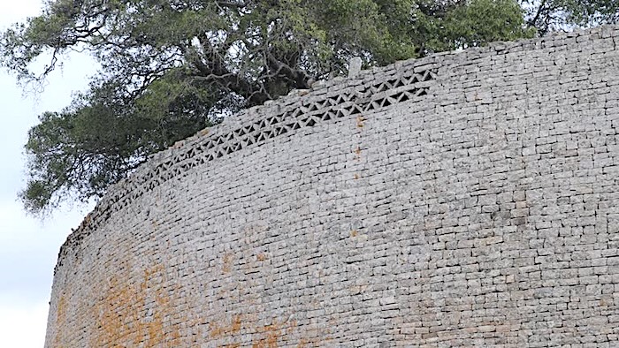 A pan to the left, showing a detail of the upper edge on the exterior wall of the Great enclosure of an ancient city complex in the south-eastern hills of Zimbabwe, which used to be the capital of the Kingdom of Zimbabwe in ancient times.