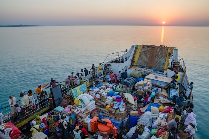 Bissau, Guinea Bissau - December 06, 2013: Old ferry heavily loaded on journey to Bubaque from Bissau during sunset, Bijagos Islands.